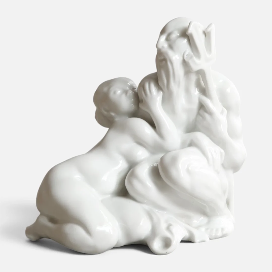 KAI NIELSEN. "Neptun & kvinde på fisk", figur af blanc de chine. Udført og mærket hos Bing & Grøndahl, dessinnr. 30. — European — Woxholt Auktionshus