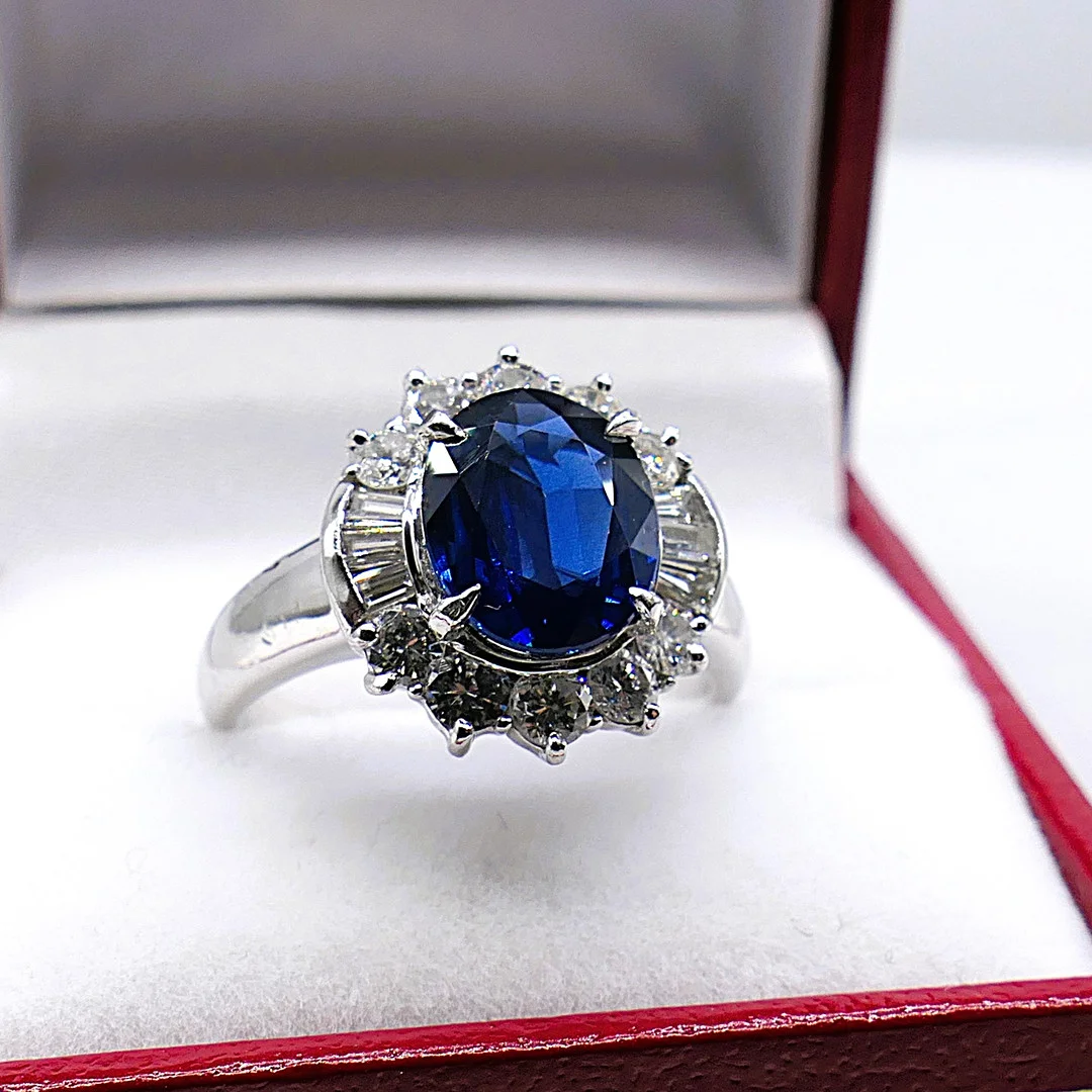 DEEP SAPPHIRE AND DIAMOND HALO COCKTAIL RING IN PLATINUM. — Rings — Rumsey’s Auctioneers