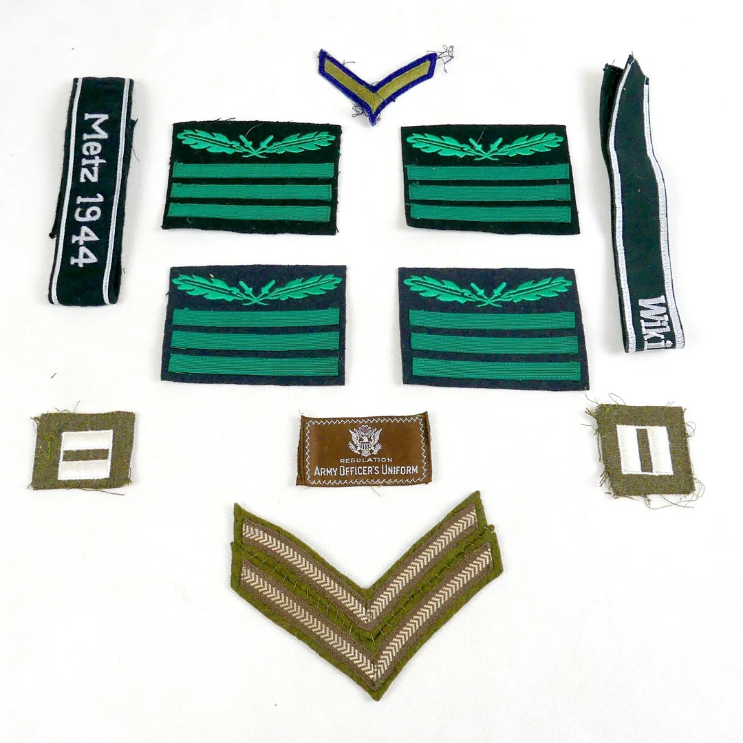 A COLLECTION OF GERMAN AND US WORLD WAR II STYLE UNIFORM CLOTH BADGES AND CUFF TITLES. — Armour & Uniform — Batemans of Stamford
