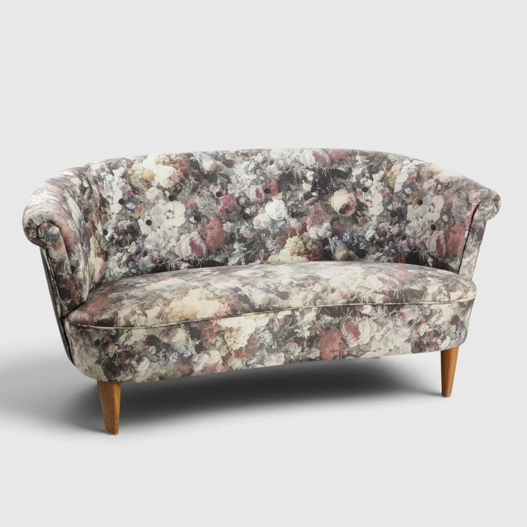 Fritstående to-pers. sofa betrukket med blomstret betræk, buet form, tilspidsede ben af massiv mahogni. Danmark, 1900-tallets midte. — Sofas & Seatings — Woxholt Auktionshus