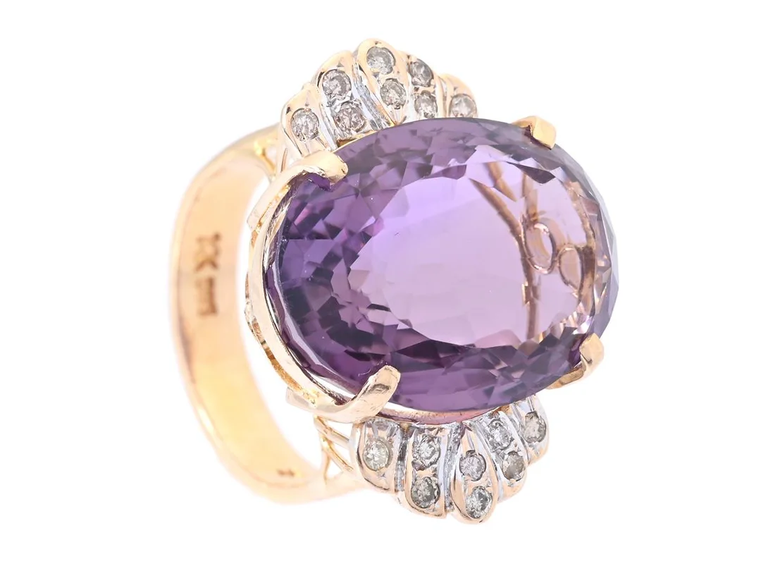 RING, 14K guld, ovalslipad ametist ca 13,1 ct, briljantslipade diamanter ca 0,24 ctv, ca TCr-C/SI-P, stl 16,5 mm, vikt 9,3 g. mittstenen något lös. — Smycken/Ring — Kaplans