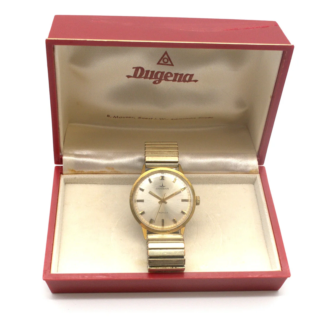 DUGENA. HERRENARMBANDUHR, "TROPICA", HANDAUFZUG , IN ORIGINAL BOX, CA. 35MM, UM CA. 1960. — Wristwatches — Kunst- und Auktionshaus Kleinhenz