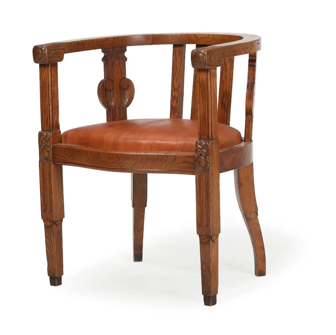 Armchair of solid oak carved with foliage, seat upholstered with nigerhide. Circa 1910. — Modern Furniture — Bruun Rasmussen