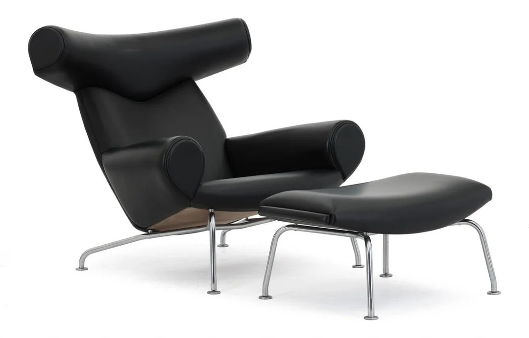 “Ox-Chair”. An easy chair and stool with steel frames. Sides, back and seats upholstered with black leather. Model EJ 100. Manufactured by Erik Jørgensen. (2) — Modern Furniture — Bruun Rasmussen