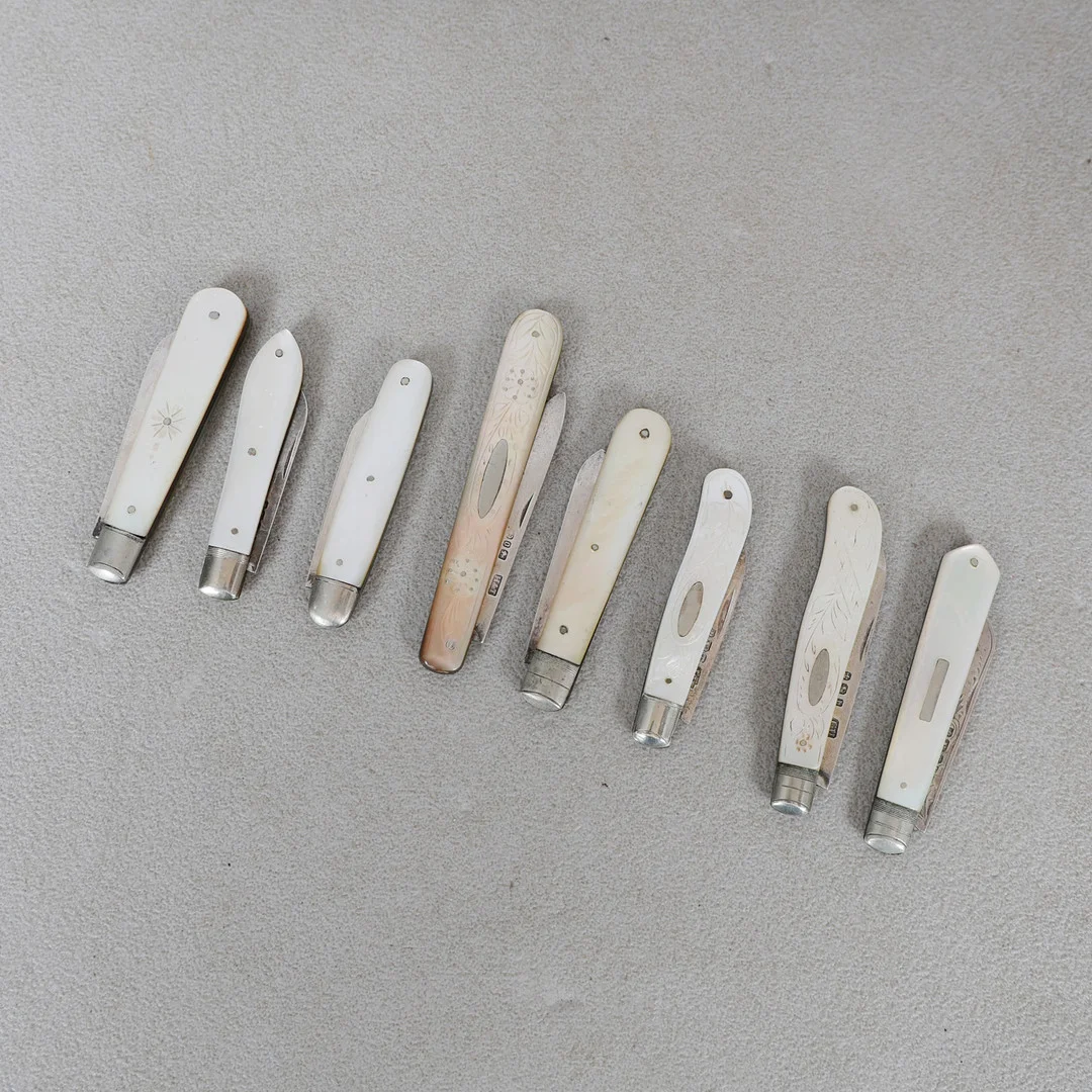 A COLLECTION OF EIGHT MOTHER OF PEARL AND SILVER BLADED FRUIT KNIVES (8). — Silver — Bishop & Miller
