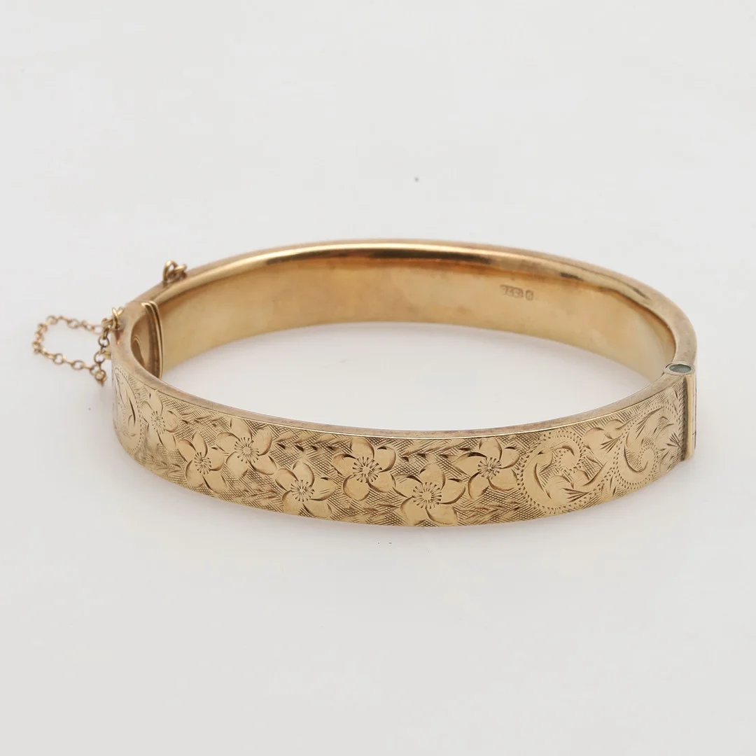 A 9CT GOLD HALF HINGED BANGLE. — Bracelets — Lawrences Auctioneers