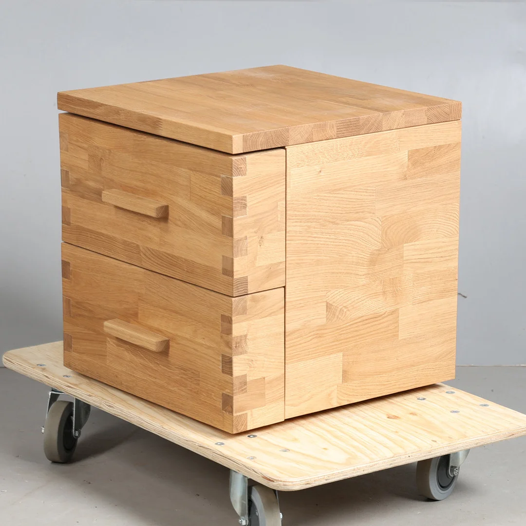 A MODERN OAK BEDSIDE CHEST. — Chests of drawers — Bishop & Miller