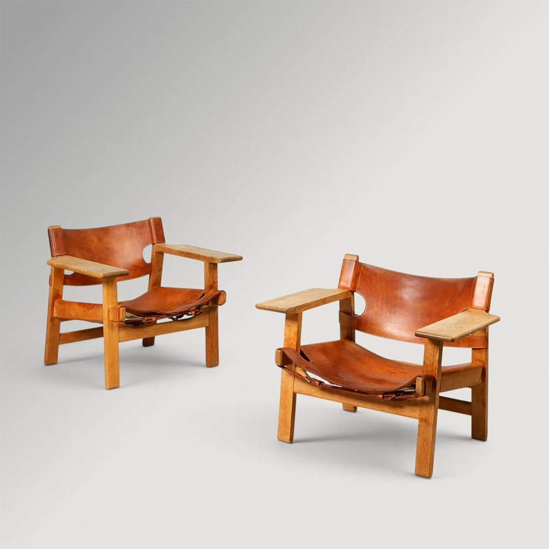 BØRGE MOGENSEN. "Den Spanske Stol", Et par tidlige armstole af patineret eg, udspændt med patineret kernelæder fra Sadelmager Dahlman, Fredericia Stolefabrik, model 226, Danmark, formgivet 1958, (2). — Armchairs & Chairs — Palsgaard Kunstauktioner