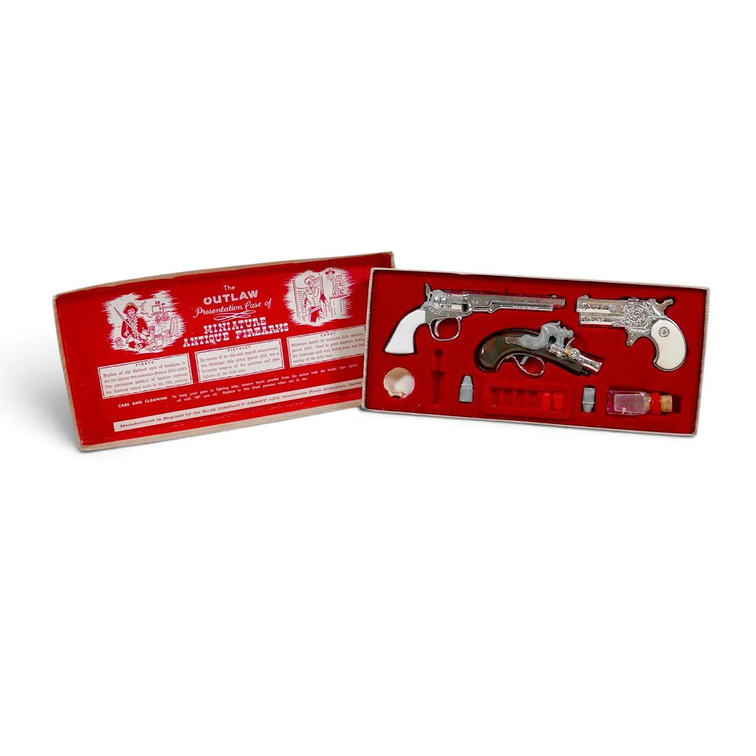 BCM (DERBY), CAP GUNS - A VINTAGE BOXED 'OUTLAW PRESENTATION CASE OF MINIATURE ANTIQUE FIREARMS'. — Other toys — Batemans of Stamford