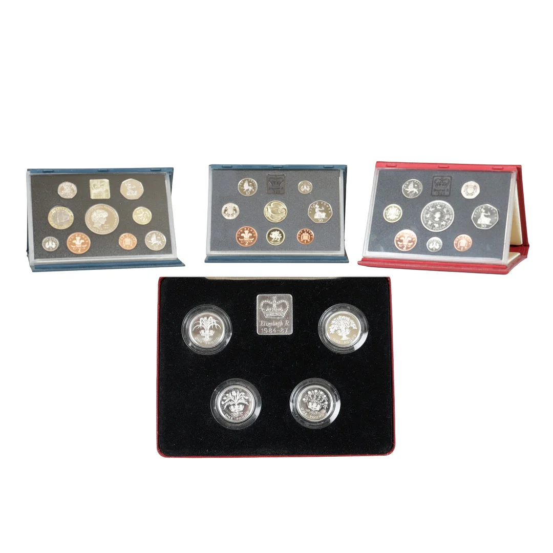 A ROYAL MINT 1984-87 UK ONE POUND SILVER PROOF COLLECTION AND THREE OTHER PROOF COIN SETS (4). — Coins & Banknotes — Bishop & Miller