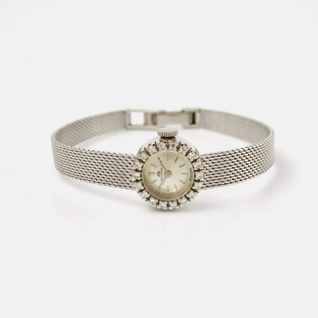 BUCHERER (Swiss Made), boett och länk 18 k vitguld, 16 mm, krans med 18 diamanter, ca 1960-tal. — Wristwatches — Stockholms Auktionsverk Sickla