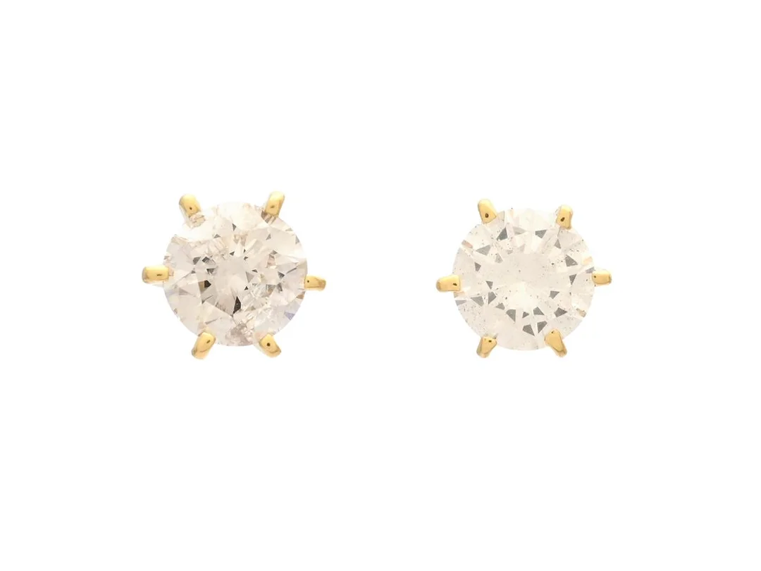 ENSTENSÖRHÄNGEN, 18K guld, briljanter ca 0,80 ctv, ca W/P2, vikt 1,2 g, ena diamanten är mjölkig, ena diamanten med natural på rondisten och inneslutning som når ytan, nagg på kuletterna. — Smycken/Enstensörhängen — Kaplans