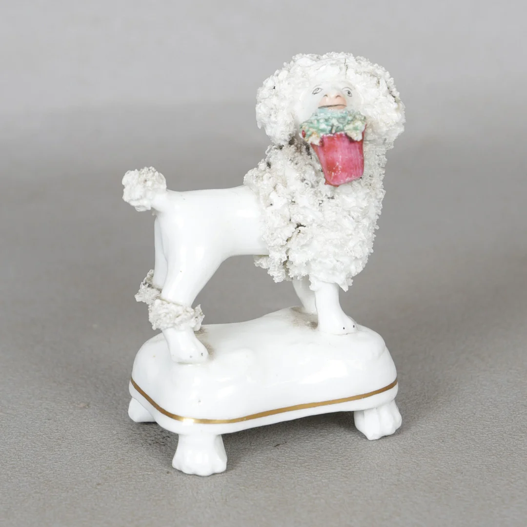 A MID 19TH CENTURY STAFFORDSHIRE POTTERY MODEL OF A POODLE. — European — Bishop & Miller