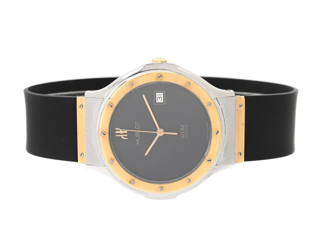 HUBLOT, Genève, MDM, Serie nr. 188637, Boett nr. S 152 10 2, herrur, 36 mm, stål/guld, quartz, safirglas, datum, skadad urtavla, integrerat gummiband, viklås (stål/guld), cert, maj 1987, box (skadad). — Klockor/Hublot — Kaplans