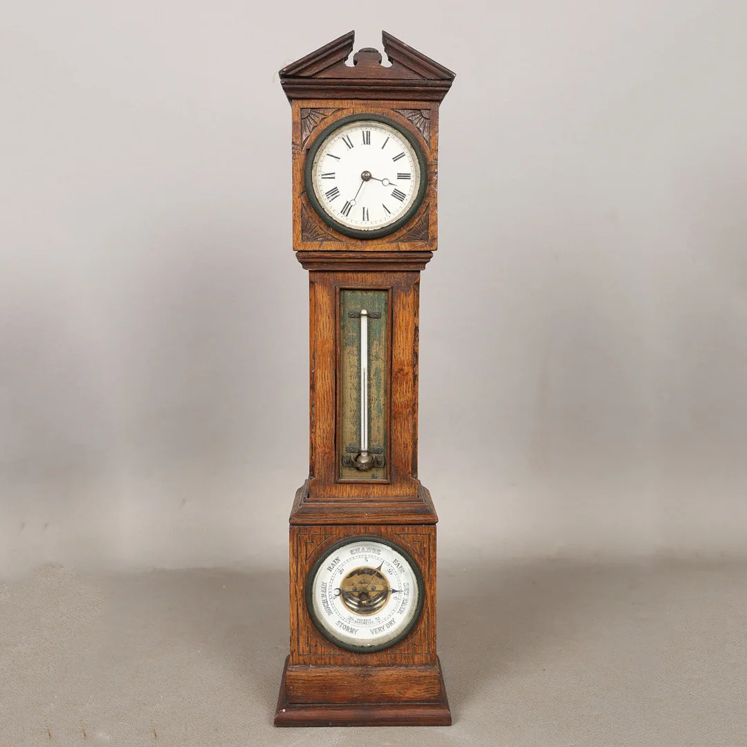 AN EARLY 20TH CENTURY TABLE TOP CLOCK AND BAROMETER IN THE FORM OF A LONGCASE CLOCK. — Other clocks — Bishop & Miller