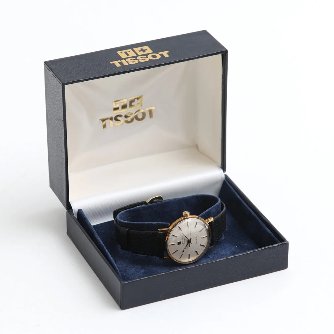 TISSOT, Seastar Seven, armbandsur, 18K guld. — Wristwatches — Auktionshuset Thelin & Johansson