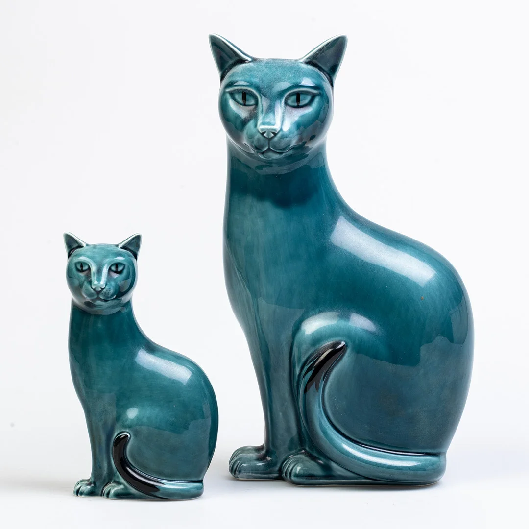 TWO POOLE POTTERY SEATED CATS AND TWO MOULDED POTTERY JUGS. — European — Griffin’s Auctioneers