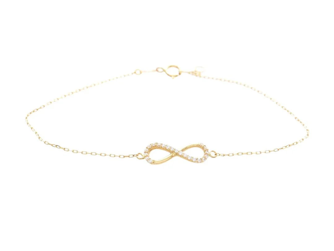 ARMBAND, 18K guld, vita stenar, evighetssymbol, längd 17,3 cm, vikt ca 0,9 g. — Smycken/Armband — Kaplans