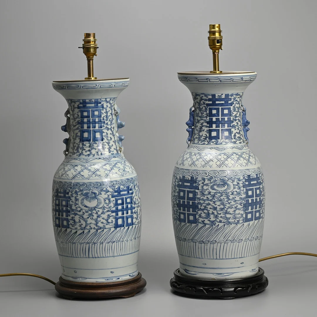 A MATCHED PAIR OF VINTAGE CHINESE BLUE AND WHITE PORCELAIN DOUBLE HAPPINESS LAMP BASES ON WOODEN STANDS. — Ceramics & Porcelain — Ma San Auction