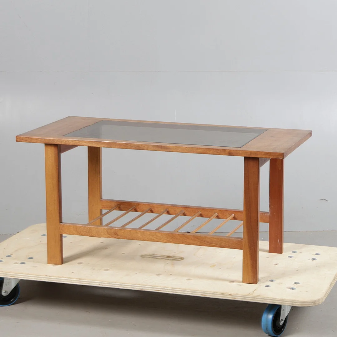 A MID 20TH CENTURY TEAK AND SMOKED GLASS COFFEE TABLE. — Dining tables — Bishop & Miller