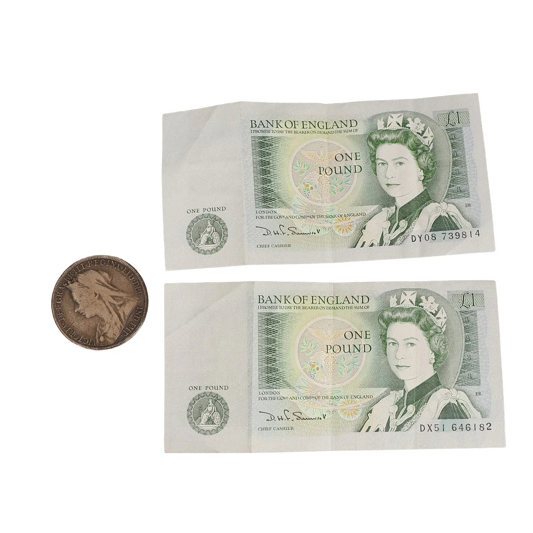 A VICTORIAN SILVER CROWN AND TWO BANK OF ENGLAND ONE POUND BANKNOTES (3). — Coins & Banknotes — Bishop & Miller