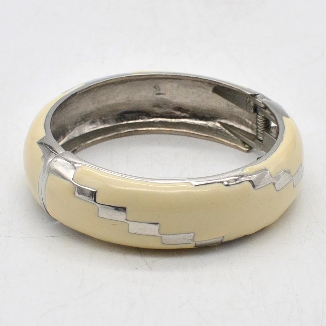 VINTAGE MODESCHMUCK ARMREIF AUS VERSILBERTEM METALL MIT EMAILLE, WEISS UND SILBER, FEDERVERSCHLUSS. — Bracelets — Kunst- und Auktionshaus Kleinhenz