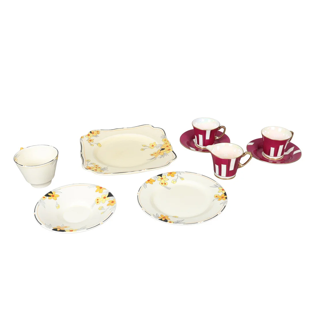 A CROWN DEVON COFFEE SET FOR TWO AND A CROWN DUCAL 'SUNBURST' PATTERN TRIO AND PLATE (QTY). — European — Bishop & Miller