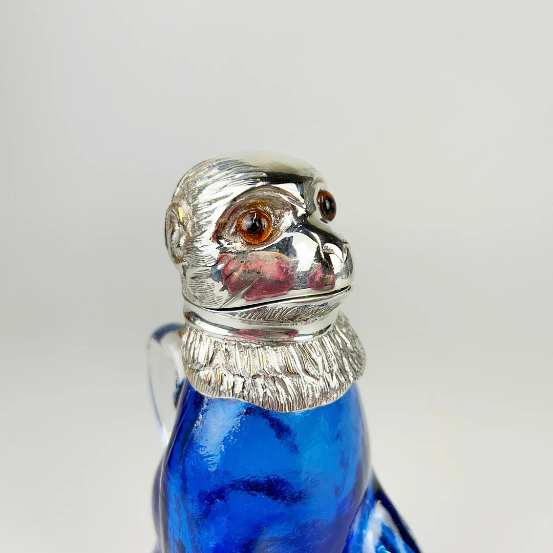 SILVER PLATED & BLUE GLASS MONKEY JUG. — Silver plated — Chalkwell Auctions
